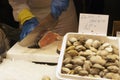 A vendor cutting fish at the Boqueria market