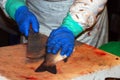 A vendor cutting fish at the Boqueria market