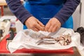 Vendor cutting fish. A typical scene at the traditional fish market