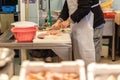 Vendor cutting fish. A typical scene at the traditional fish market