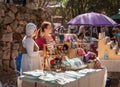A vendor dressed in medieval clothing sells homemade things at the Knights of Jerusalem Festival at the Ein Yael Museum, in
