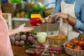 Vendor giving bell pepper to the woman at the grocery store Royalty Free Stock Photo