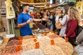 Vendor meeting group of people for degustation at the Machane Yehuda Market in Jerusalem, Israel