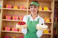 Vendor in pastry shop hold two nice cakes in hands Royalty Free Stock Photo