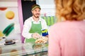 Vendor in pastry shop selling sweets to costumer Royalty Free Stock Photo