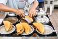 Vendor preparing traditional delicious apam balik or peanut pancake in food eatery Royalty Free Stock Photo