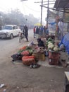 Vendor saleing fruits &vegetables on the road side public moment