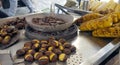 A vendor sell roasted corn and chestnuts