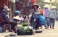 Vendor selling greens in market in Hoi An