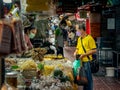 Vendor selling products to a client in Chinatown on a street side, Bangkok, Thailand