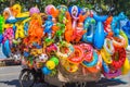 A vendor sells colorful beach toys and floats.