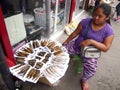 A vendor sells dried and smoked fish along a street in Antipolo City, Philippines