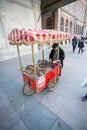 A Vendor Sells Food on a Street Corner