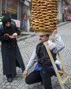 A vendor sells simit, a type of Turkish bread, in the streets of