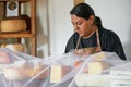 Vendor serving variety of traditional cheese in a cheese farm store