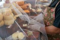 Vendor serving variety of traditional cheese in a cheese farm store