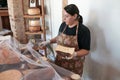 Vendor serving variety of traditional cheese in a cheese farm store