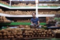 Vendor sits behind a large pile of coconuts in New Market in Kolkata