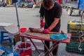 Vendor slices large fish at local farmers market Royalty Free Stock Photo