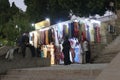 Vendors entice tourists to buy clothing and other souvenirs