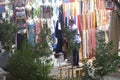 Vendors entice tourists to buy clothing and other souvenirs