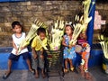 Vendors prepare palm leaves to be sold to church patrons in preparation for the Palm Sunday