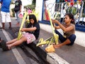 Vendors prepare palm leaves to be sold to church patrons in preparation for the Palm Sunday