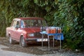 vendors sell homemade wine from their cars on the side of the street