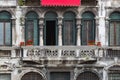 Red flowers on a vintage balcony in Venice. Royalty Free Stock Photo