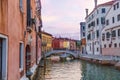 Venetian building at sunset with boats and amazing sky over Grand canal. Royalty Free Stock Photo