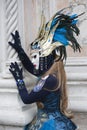 Venetian Carnival Figure in a colorful blue and gold costume and mask Venice Italy Royalty Free Stock Photo