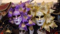 Venetian carnival masks in purple and gold for sale in the stalls Royalty Free Stock Photo