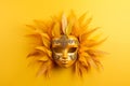 Venetian carnival yellow mask with feathers on bright yellow background. Masquerade mardi gras concept. banner, greeting card