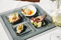 Venetian Cicchetti with shrimps, scallop, octopus and potatoes, and sea bass Royalty Free Stock Photo