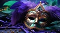 Venetian gold mask with beads and feather decoration in the traditional Mardi Gras colors of purple and green Royalty Free Stock Photo