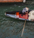 Venetian gondola on river photographed from above with italian man on boat