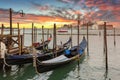 Venetian gondolas at the harbor and San Giorgio Maggiore island at sunset, Venice. Italy