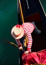 gondolier with hat rowing on gondola boat on grand canal in Venice in Italy Royalty Free Stock Photo