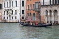 Venetian gondolier rowing gondola with tourists through the Grand Canal, Venice, Italy Royalty Free Stock Photo