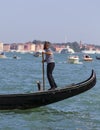 Venetian gondolier rowing through the Grand Canal, Venice, Italy Royalty Free Stock Photo
