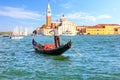 A venetian gondolier sailing to San Giorgio Maggiore island