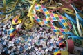 Venetian harlequin style mask with confetti and trumpets around on a marble table