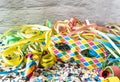 Venetian harlequin style mask with confetti and trumpets around on a marble table