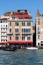 Venetian hotel facade with windows, pontoon and water