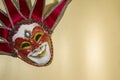 Venetian jester mask on a gold background, top view