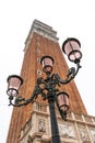 Venetian lamppost with the bell tower of San Marcos in the background