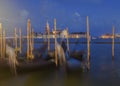 venetian landscape of some gondolas and san giorgio church in the background. blue hour