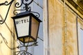 Venetian lantern wrought iron street lamp with hotel sign Royalty Free Stock Photo