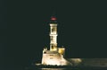 Venetian Lighthouse Located at the End of the Pier, at the Entrance of the Port. The Symbol of Chania.Illuminated Beacon at Night
