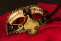 Venetian mask on red, black background. Royalty Free Stock Photo